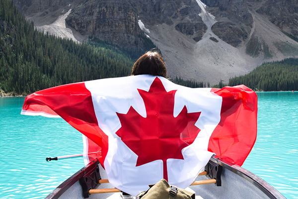 holding Canadian Flag in canoe